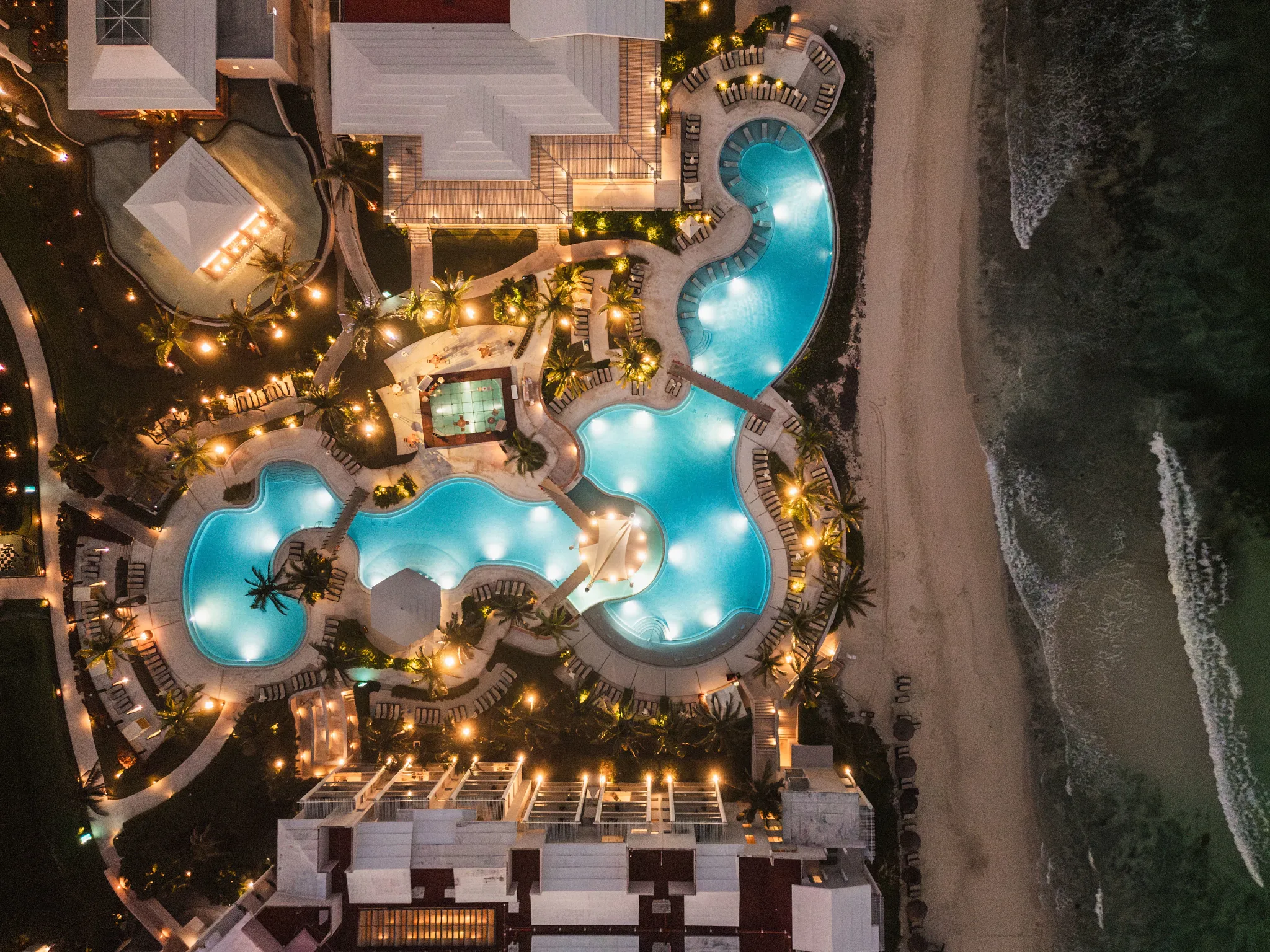 Aerial of a pool setup for meetings at night with lights