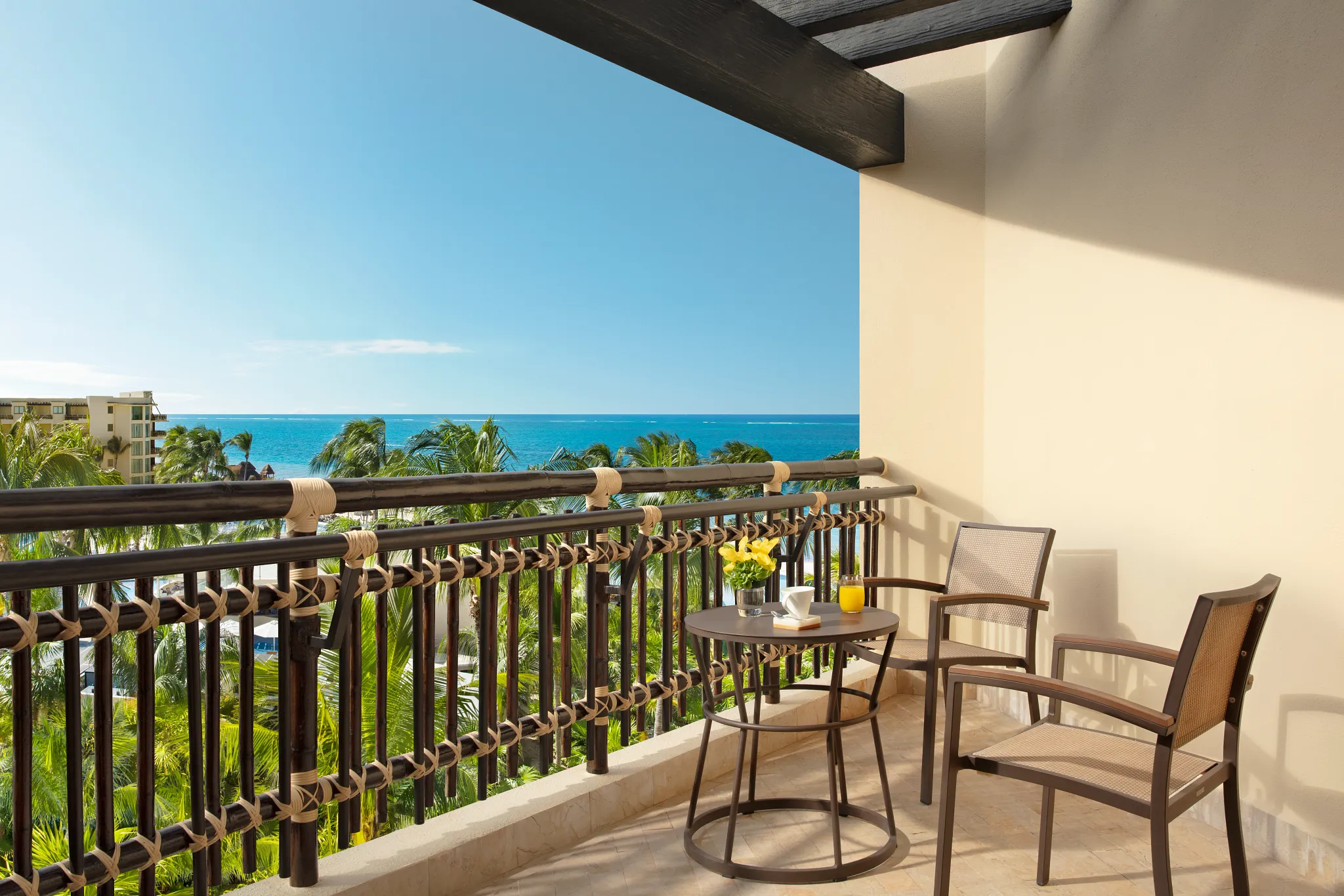 Room balcony with chairs and a table and an ocean view