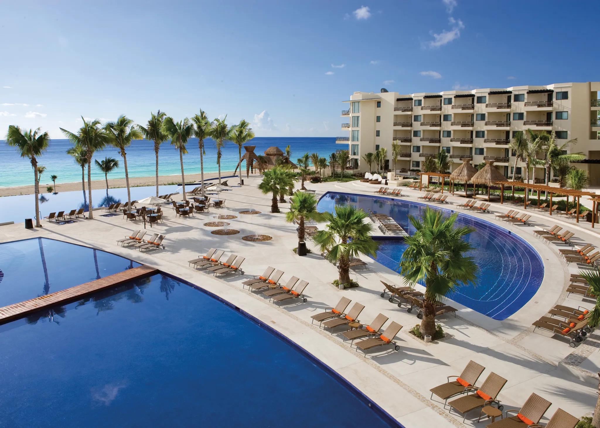 Exterior shot of the two pools one smaller and another larger pool with an in pool walkway