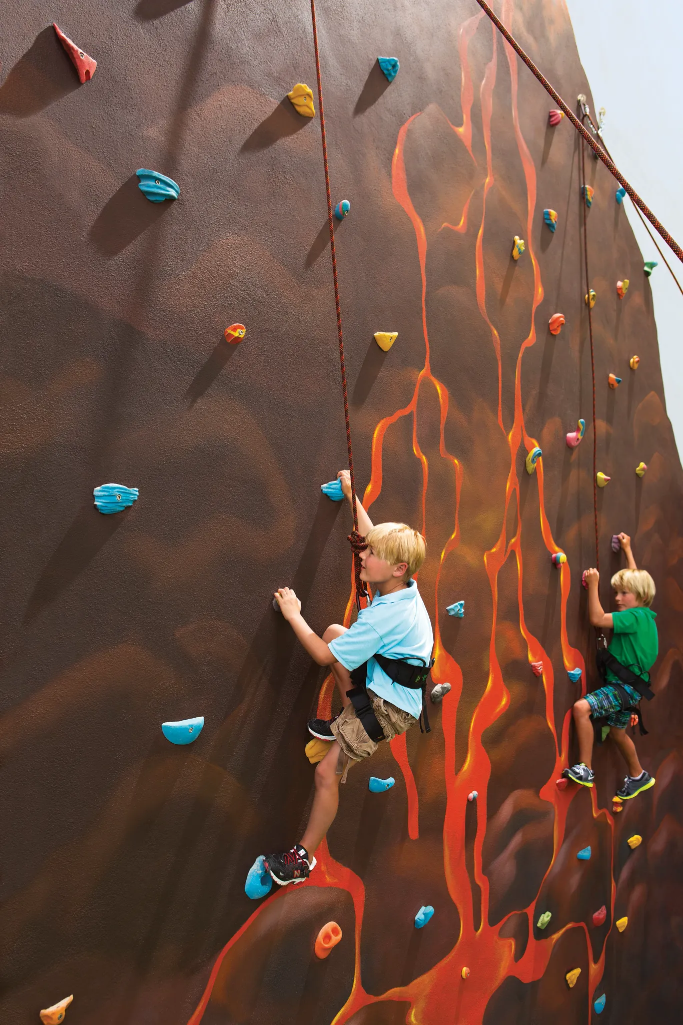two kids enjoying a rock climbing wall