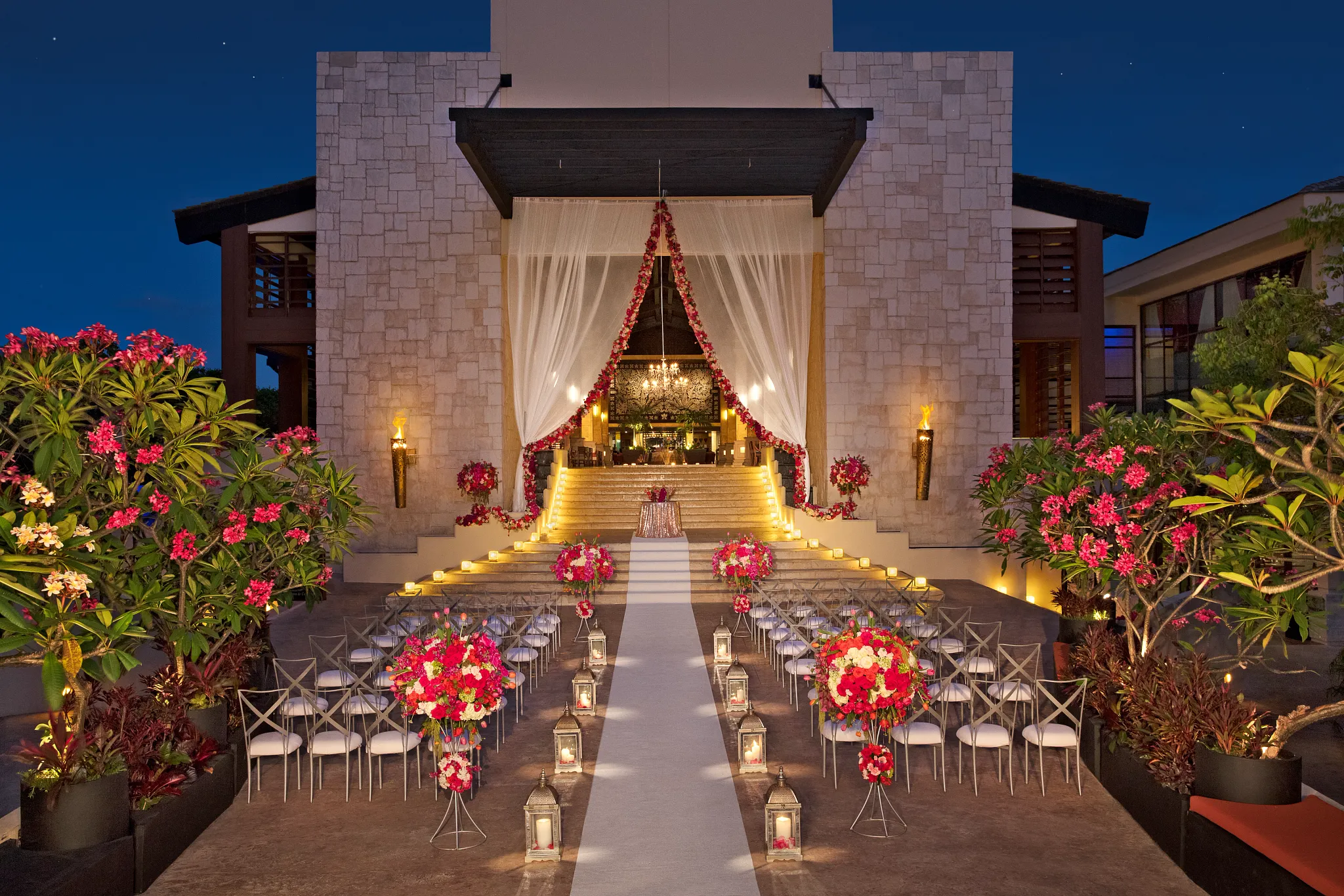 Wedding ceremony at night set up at the entrance of the Dreams resort on the stairs