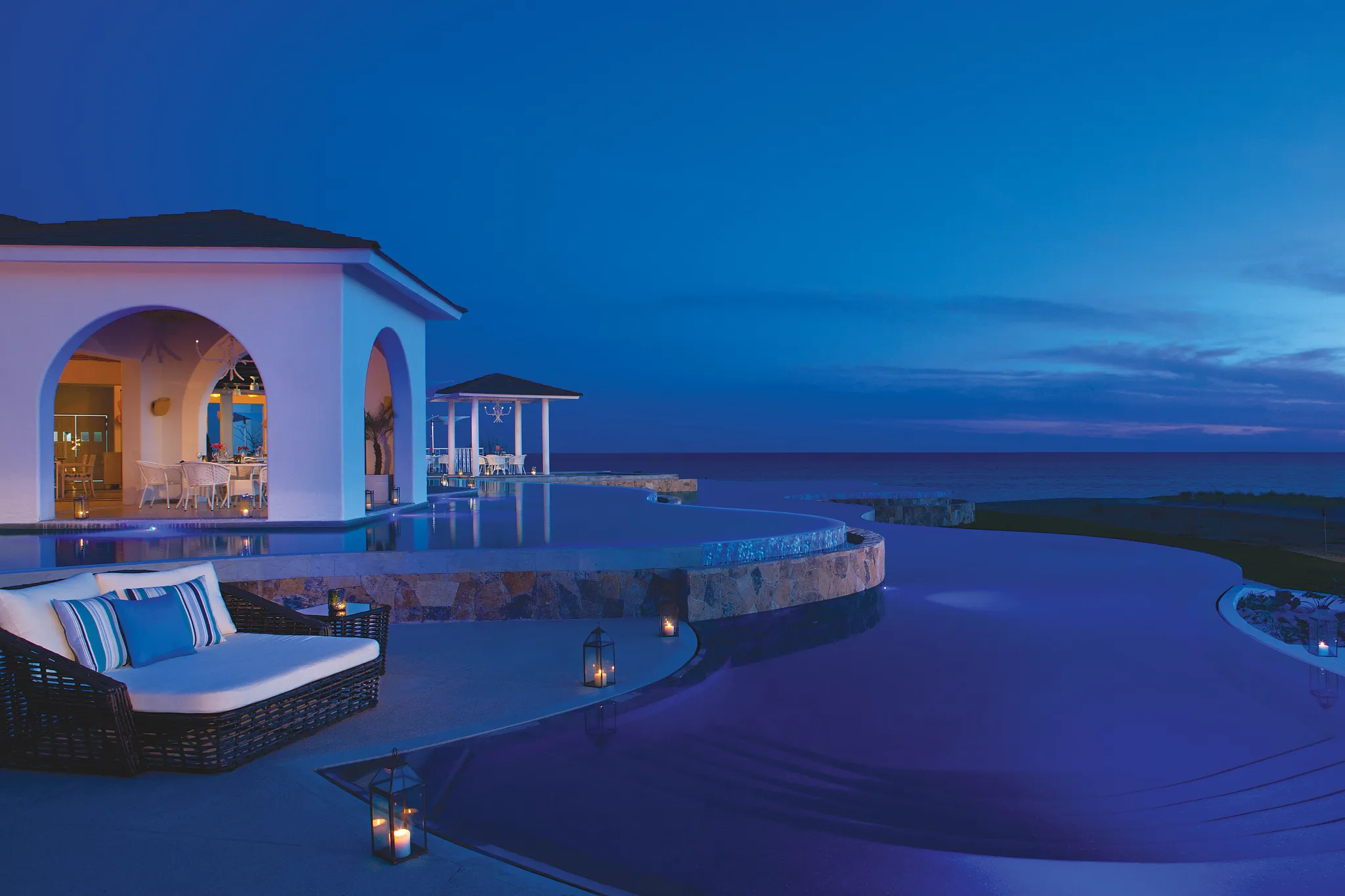 view of pools and restaurant terrace at night