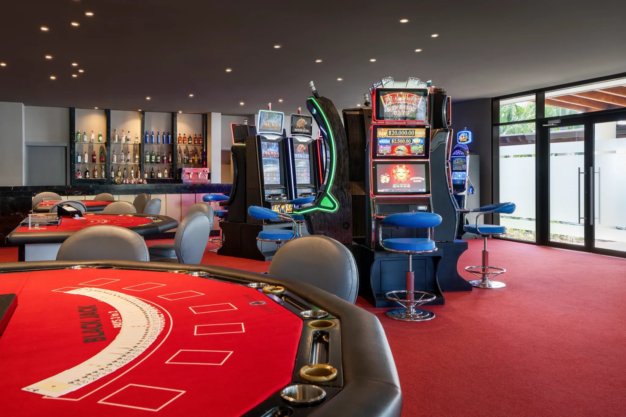 Casino at resort with black jack table, slot machines and bar