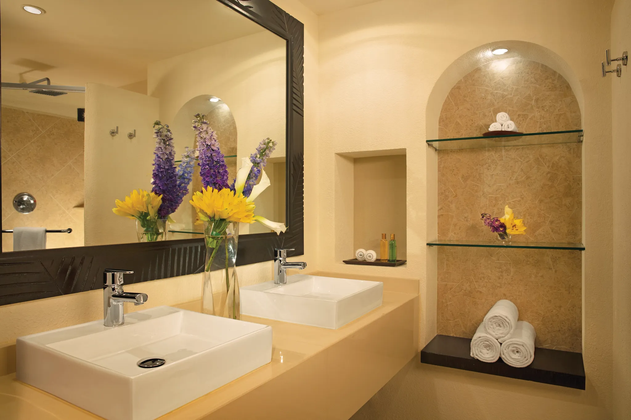 Private Bathroom Displaying Double Sink, Towels, and Wide Vanity Mirror