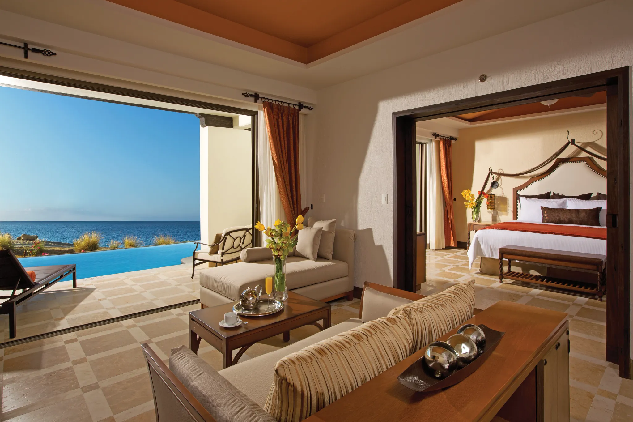 living area and bedroom of large hotel suite with a swimout pool