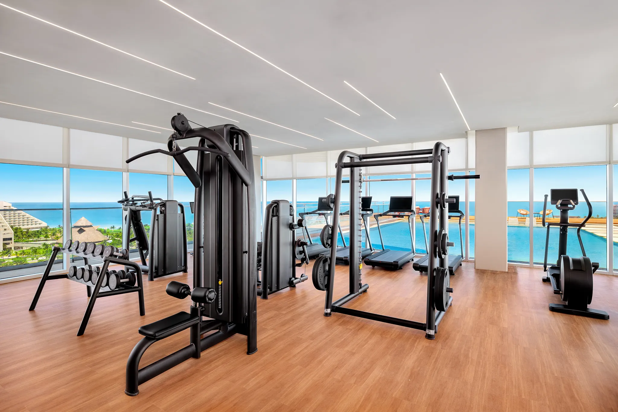 Rooftop gym with beautiful views of the pool and ocean