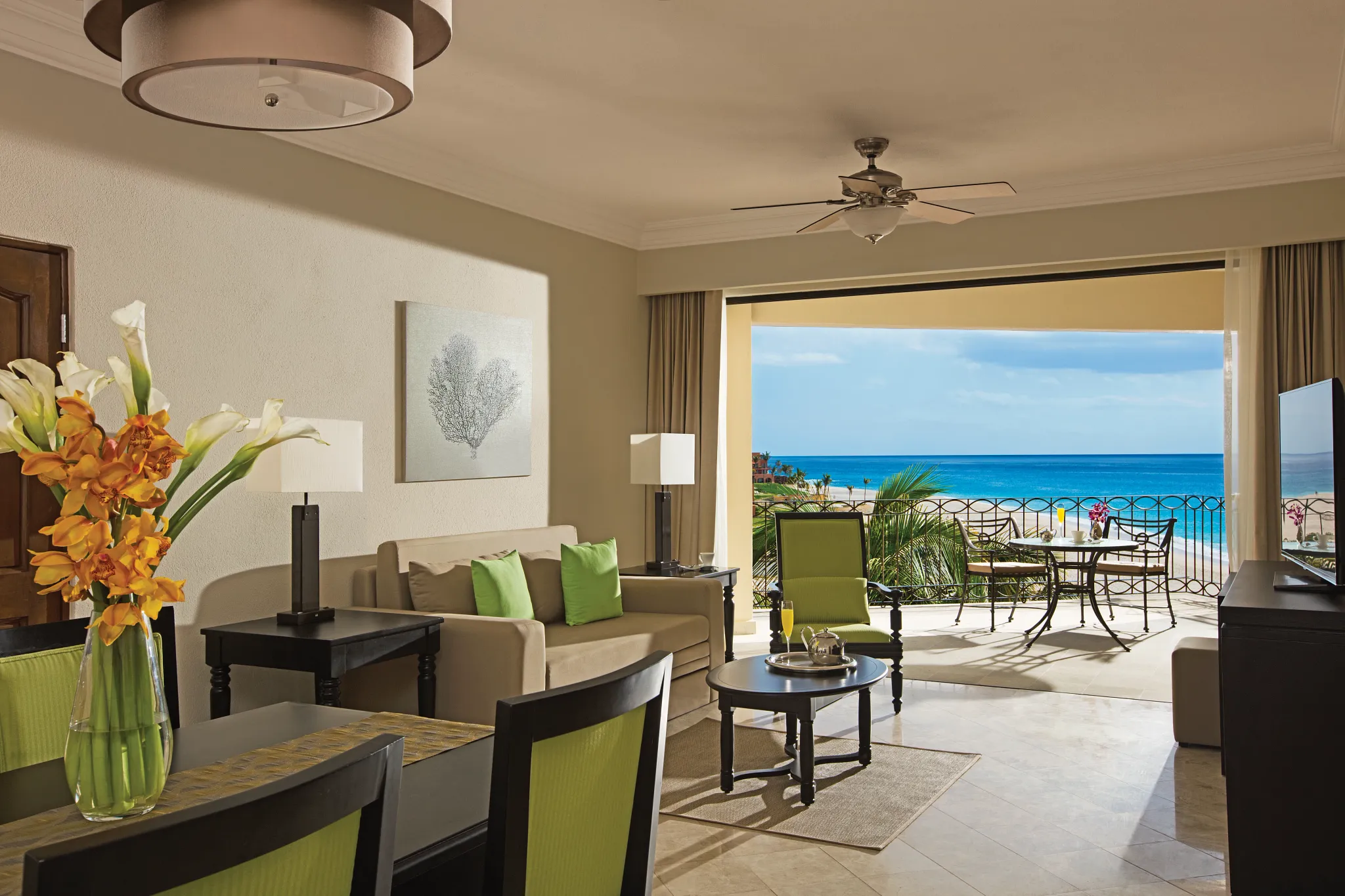 large suite with living area and balcony with ocean view