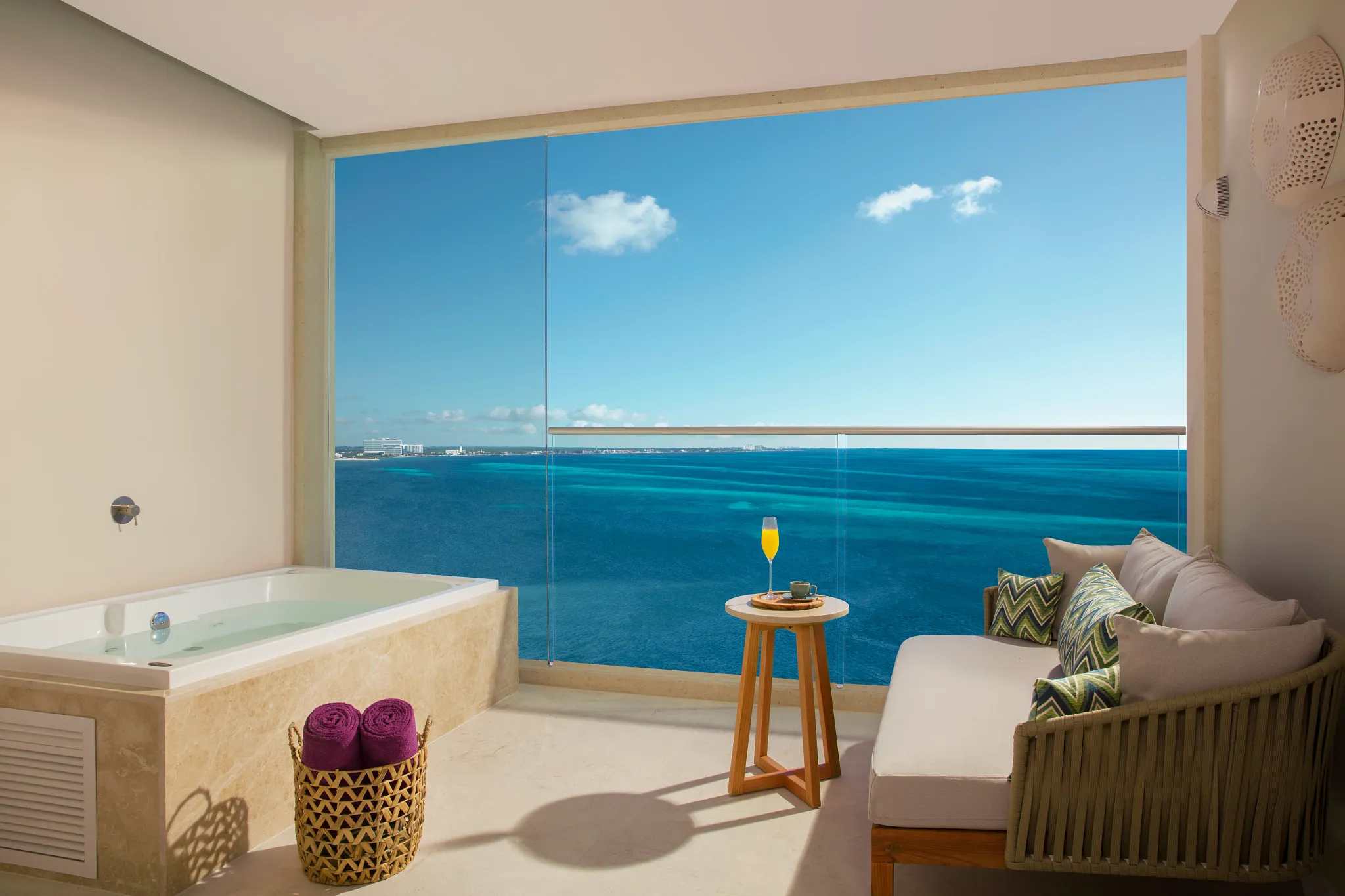 furnished balcony with a hot tub and ocean front view of the Caribbean Sea